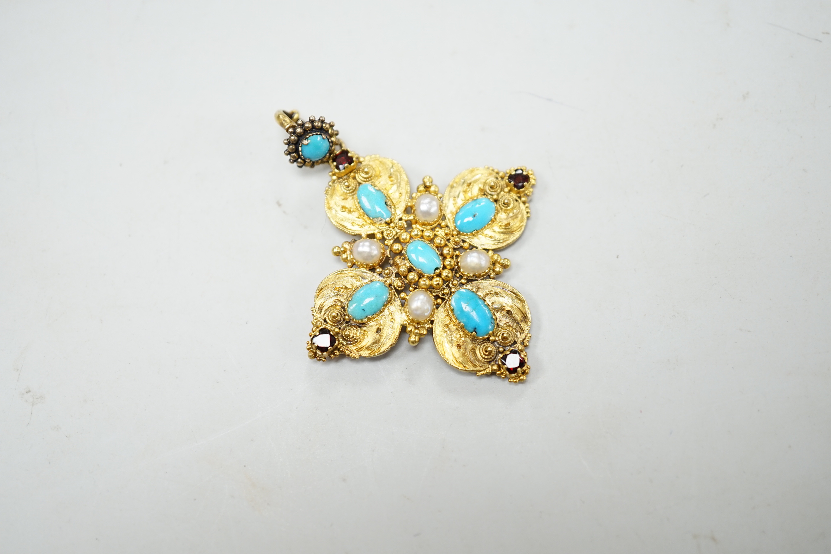 A 19th century yellow metal, turquoise, split pearl and garnet set quatrefoil pendant, overall 5cm, gross weight 7.5 grams.